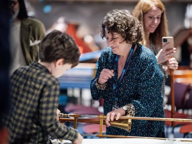 Boy looking at instrument at the Bate Collection of Musical Instruments